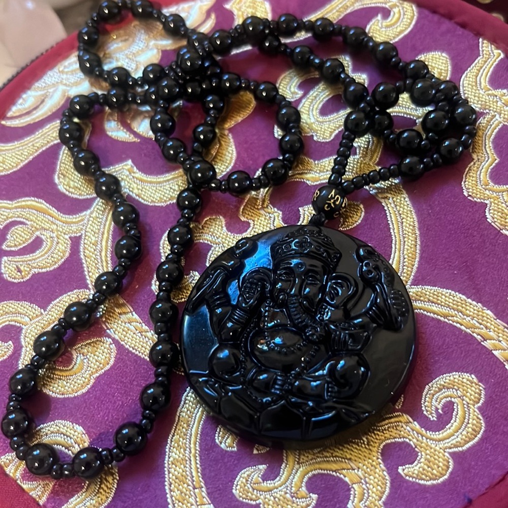 Ganesha black obsidian pendant. With mantra bead for compassion.